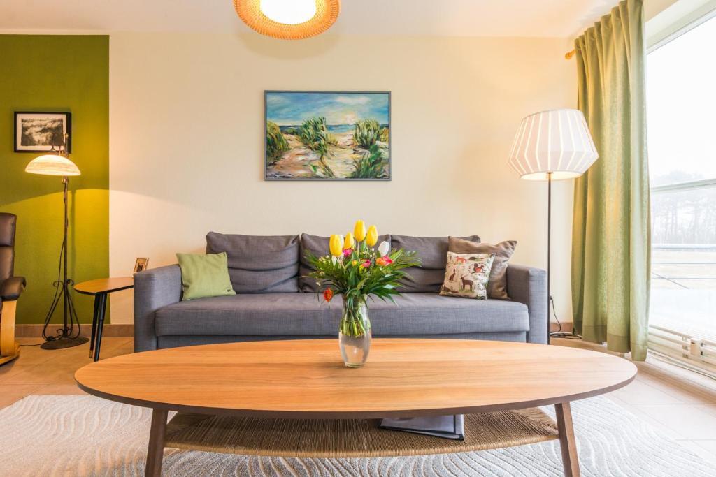 a living room with a couch and a table at Ostseeresidenz - Whg 14 in Zingst