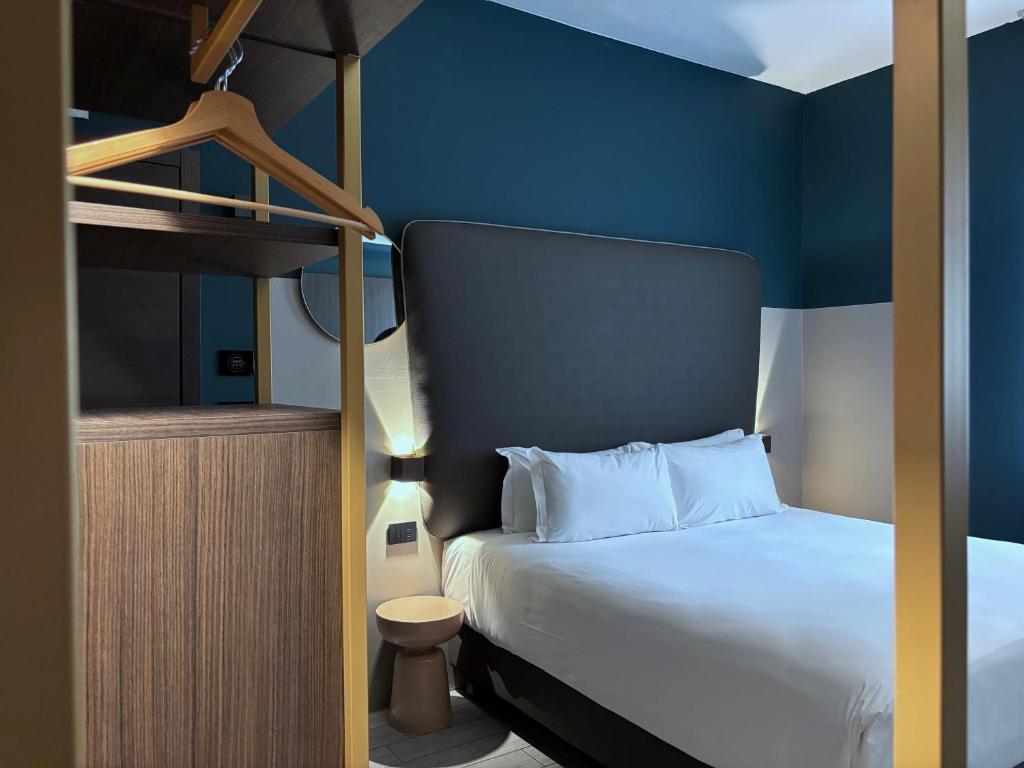 a bedroom with a bunk bed and blue walls at AV Hotel Milano in Milan