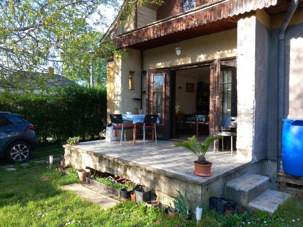 a porch of a house with a table and chairs at Kisfaludy Apartment House in Gárdony