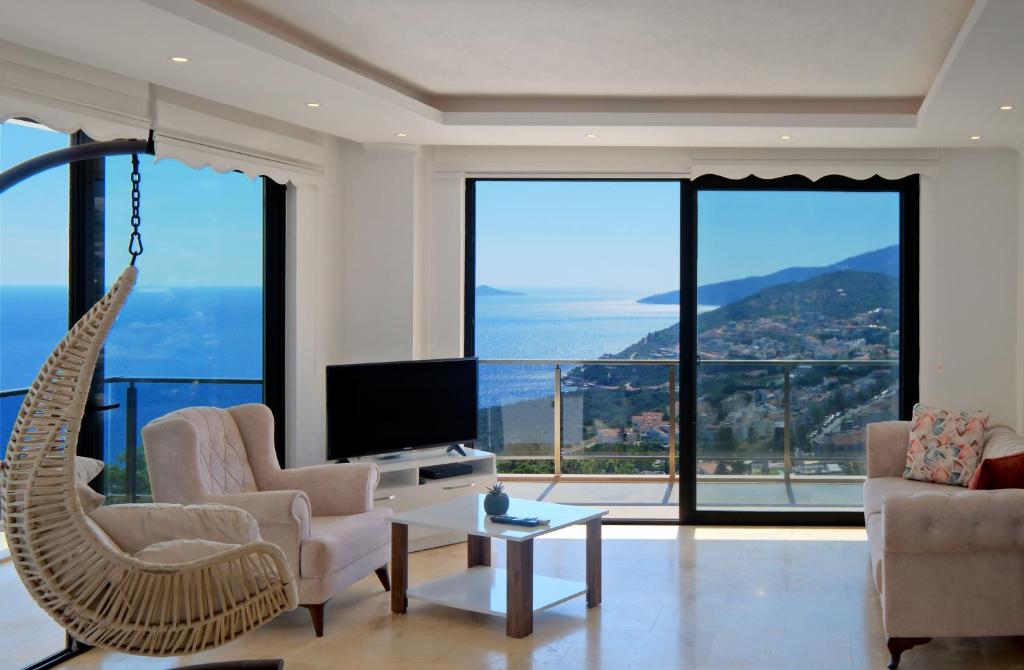 a living room with a couch chair and a television at Villa Sheyma in Kalkan