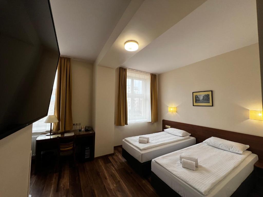 Postel nebo postele na pokoji v ubytování Memel Hotel