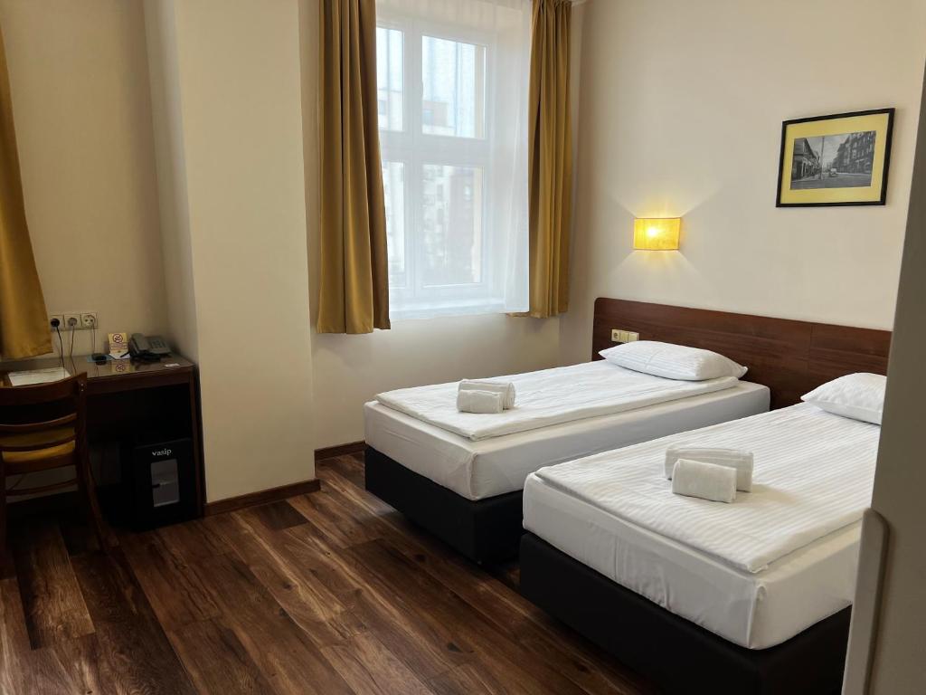 Postel nebo postele na pokoji v ubytování Memel Hotel