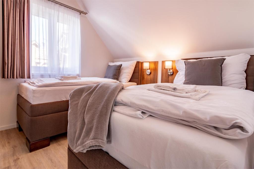 a bedroom with two beds and a window at Lipno Village House in Frymburk