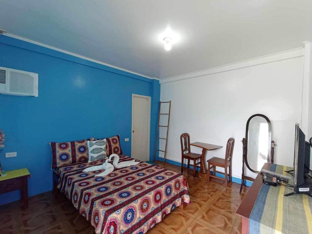 Ein Bett oder Betten in einem Zimmer der Unterkunft Villa Consuelo Pagudpud