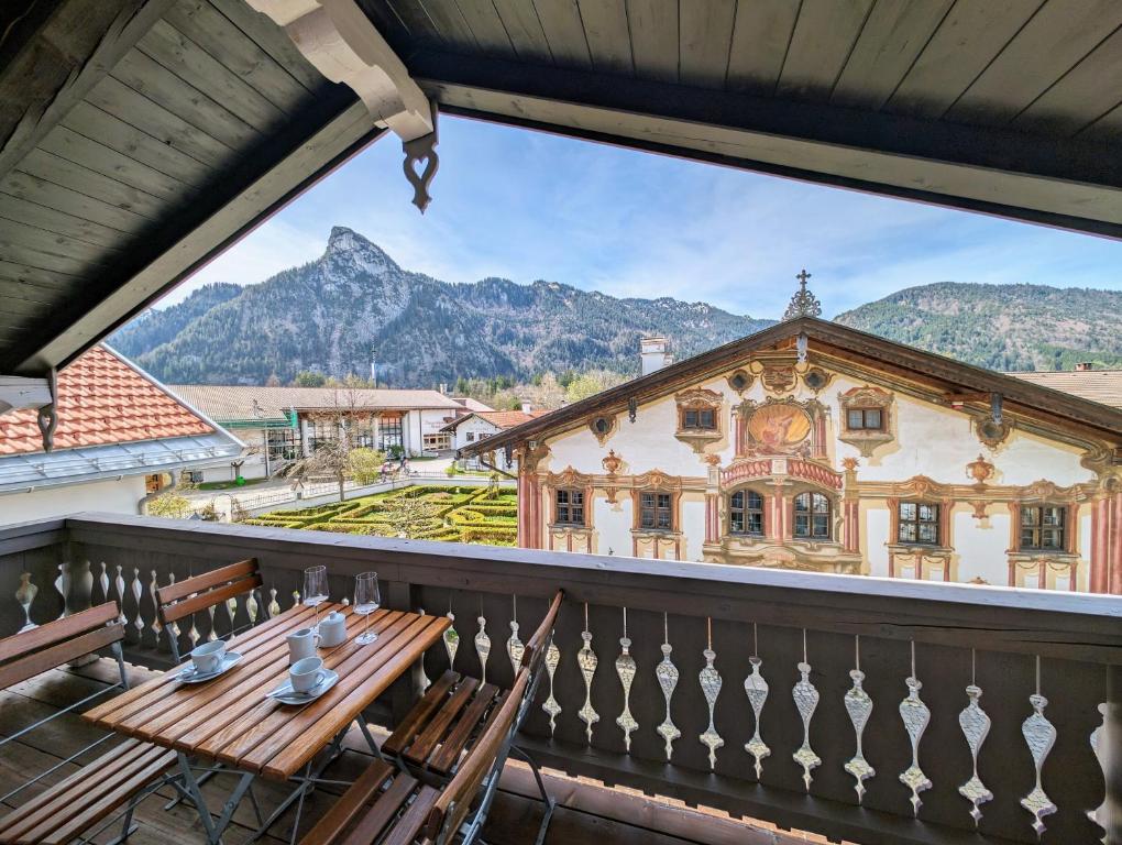 a view from the balcony of a house with a table and chairs at Neu! Moderner bayrischer Flair vor Pilatushaus in Oberammergau