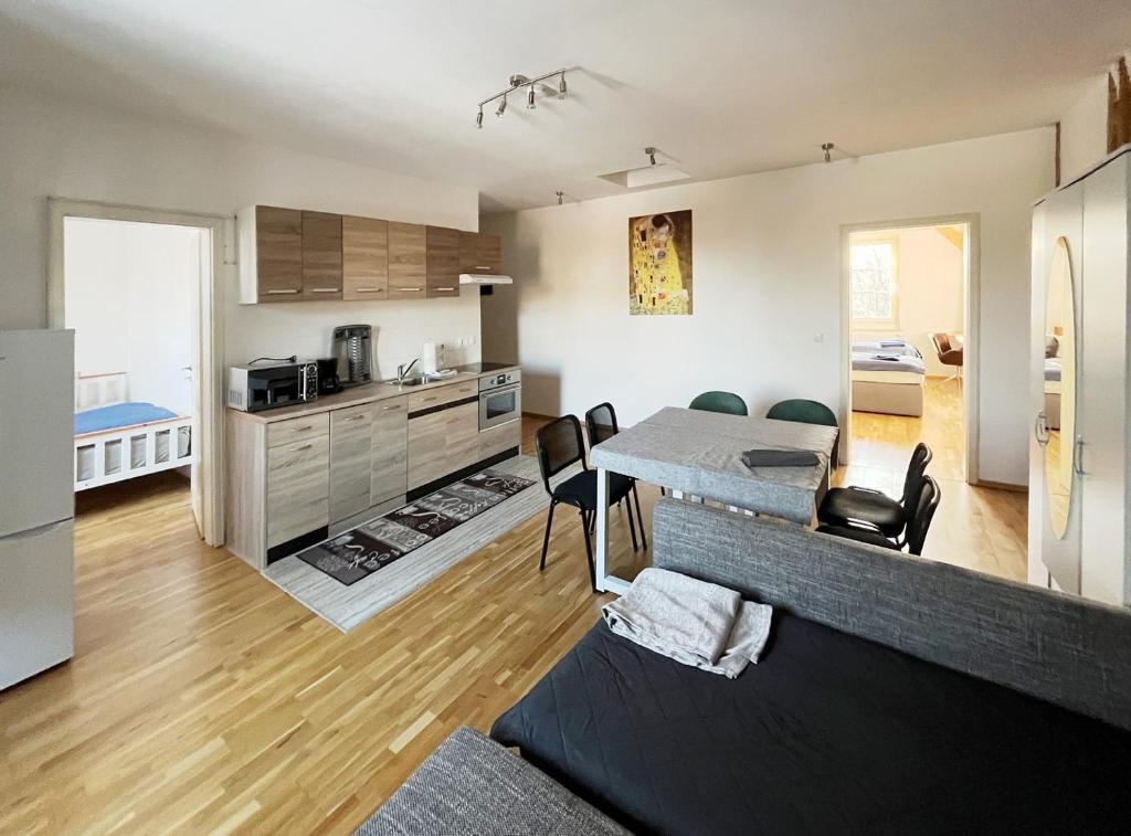 a kitchen and living room with a table and chairs at Apartments-Alt-Marzahn in Berlin