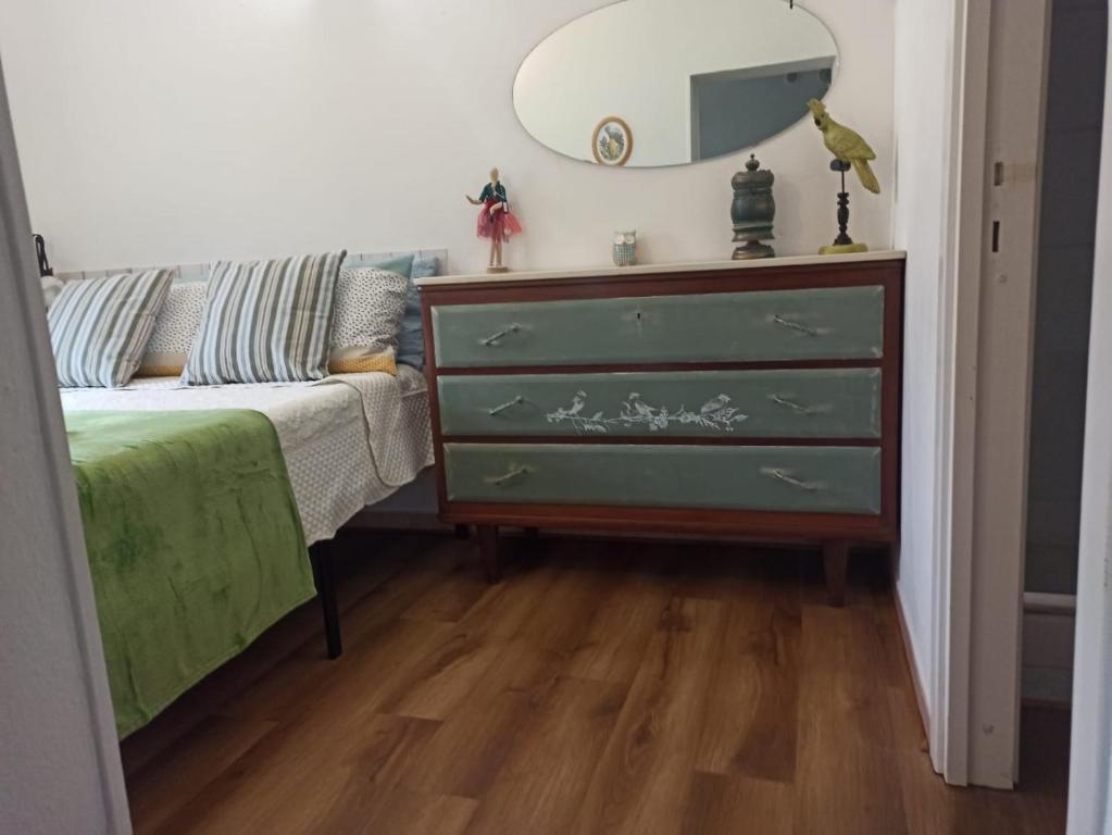 a bedroom with a dresser and a green dresser at La Maisonette in Sori