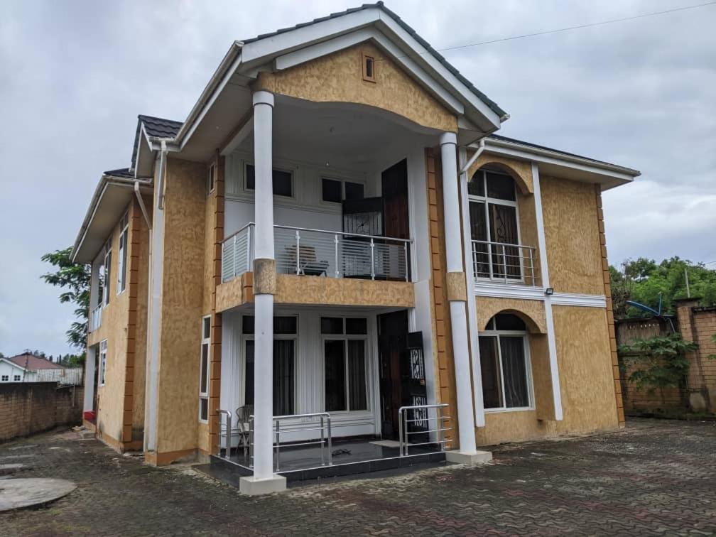 a building with a balcony on the side of it at Mjengoni in Dar es Salaam