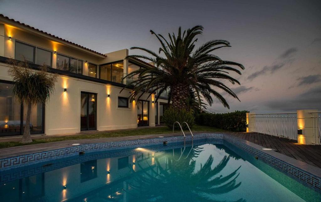 una casa con piscina frente a una casa en Zula House - Stunning designer villa in spectacular location, en Caniço