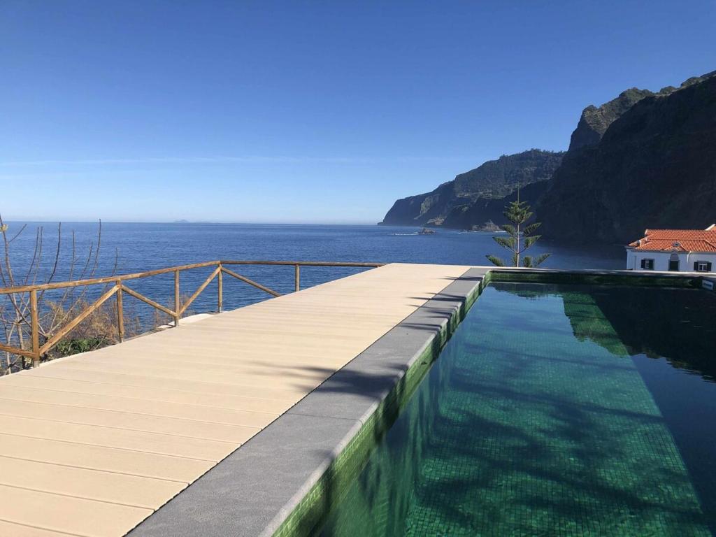 a swimming pool with a view of the ocean at Casa Del Mar - Vistas Maravilhosas do Mar e Piscina in Ponta Delgada