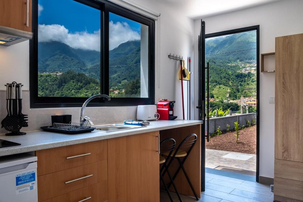 a kitchen with a sink and a large window at GuestReady - Tranquil Retreat in Nature's Embrace in São Vicente