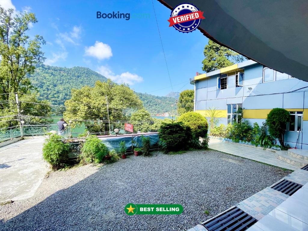an image of a house with a gravel driveway at CENTRAL HOTEL by RB group Mall Road-prime-location in-front-of-naini-lake hygiene-and-spacious-room in Nainital