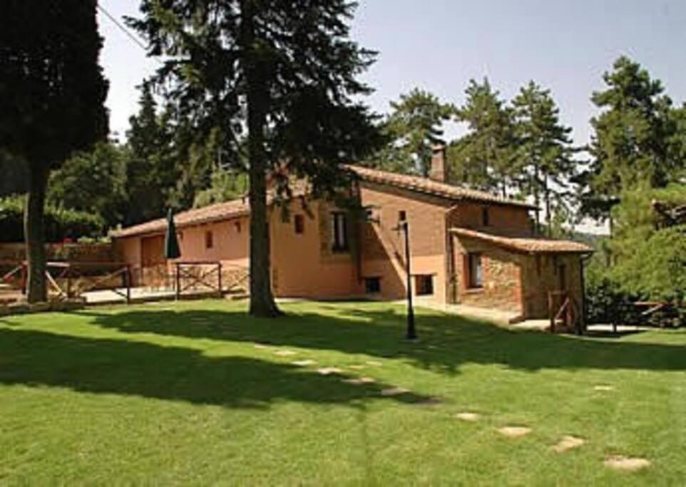 uma casa com uma árvore num jardim relvado em Villa Giara - Piscina vista Lago Trasimeno Umbria em Paciano
