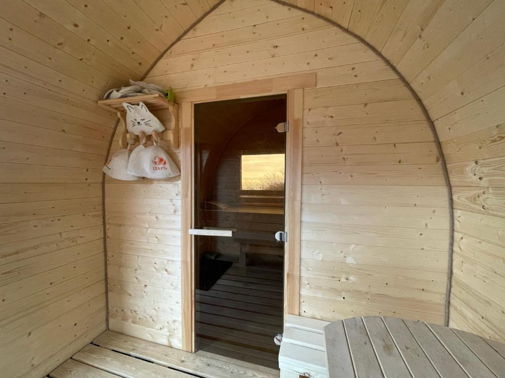 an inside view of a sauna with a door at SweeDom Shale in Almaty