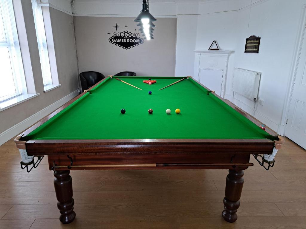 a pool table with balls on it in a room at The Old Post Office in Morriston