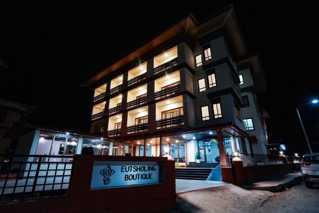 a building with a sign in front of it at night at Eutsholing Boutique Hotel in Thimphu