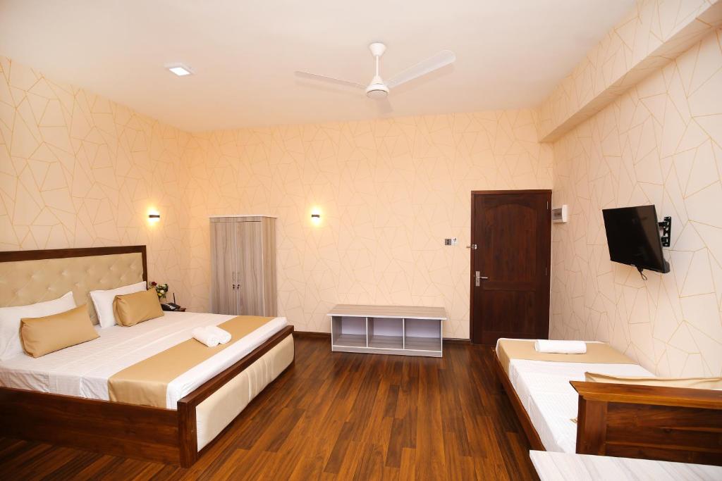Postel nebo postele na pokoji v ubytování CROWN REGENCY- BADULLA