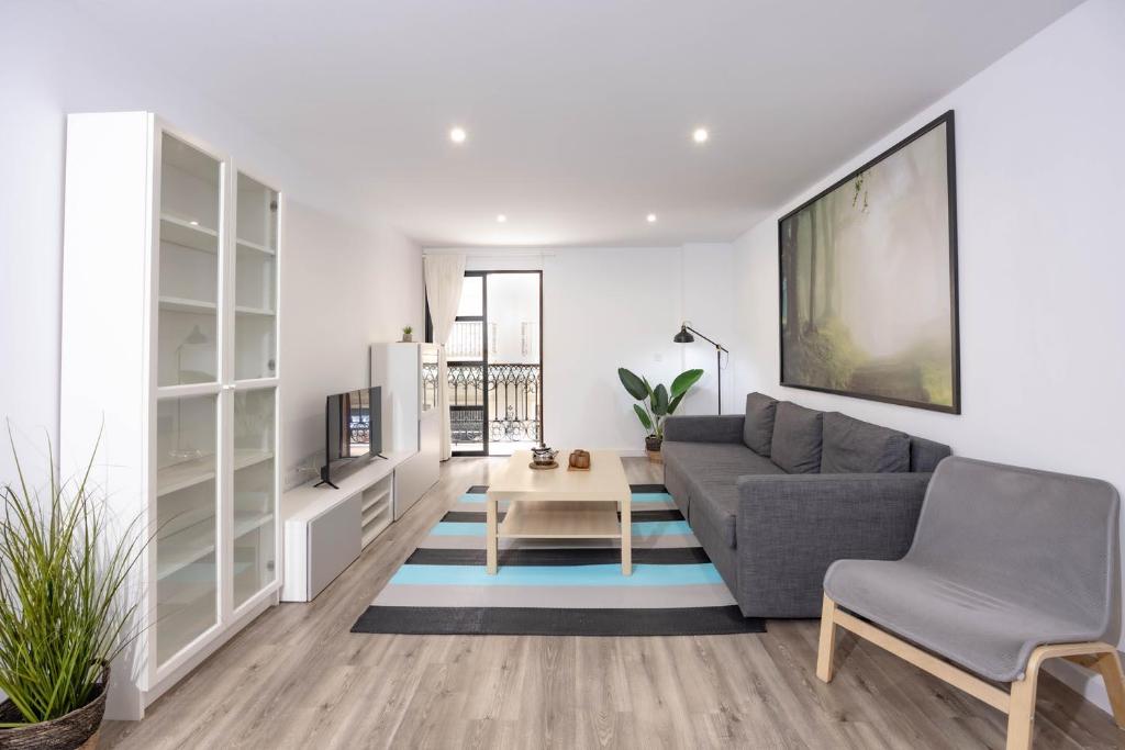 a living room with a couch and a table at Apartamentos Turísticos Puerto Cartago by CartagenaSpain in Cartagena