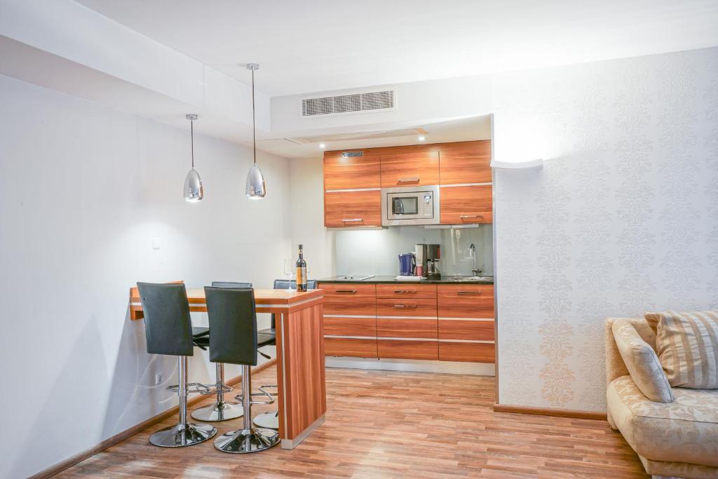 a kitchen with a table and chairs in a room at Arkona Strandresidenzen in Binz