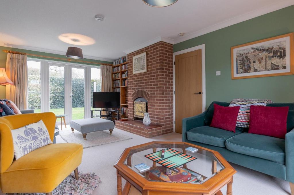 a living room with a couch and a fireplace at Buntings in Walberswick