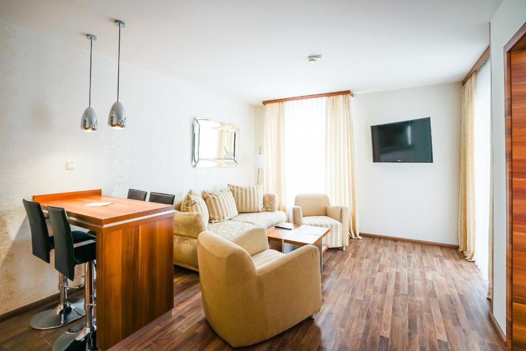 a living room with a couch and a table at Arkona Strandresidenzen in Binz