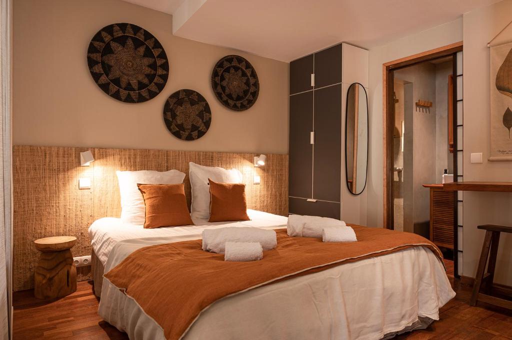 a bedroom with a large bed with two pillows at Cepoun - Grand studio centre Saint-Tropez in Saint-Tropez