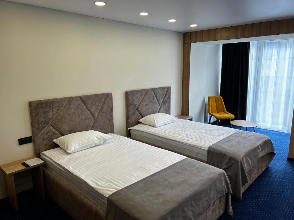 Ένα ή περισσότερα κρεβάτια σε δωμάτιο στο Optima Collection Kamianske