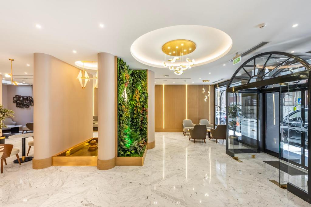 an office lobby with a large vertical aquarium at Hotel Bristol in Istanbul