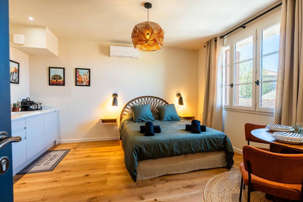 a bedroom with a bed with blue pillows in it at OUSTAU DE MARIE in Saint-Rémy-de-Provence