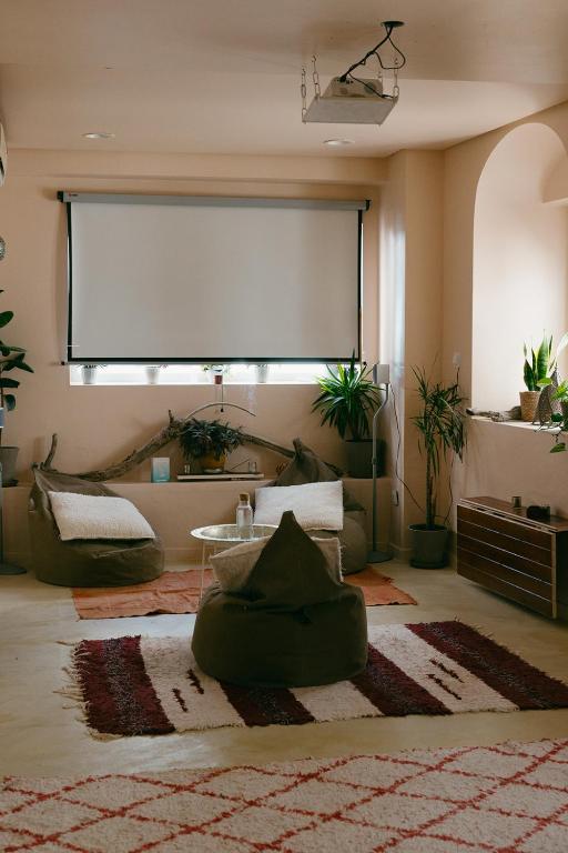 a living room with a large projection screen on the wall at Casa Africa in Tarifa