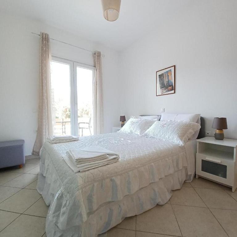 Postel nebo postele na pokoji v ubytování Eleonas Apartment 2, Lygia