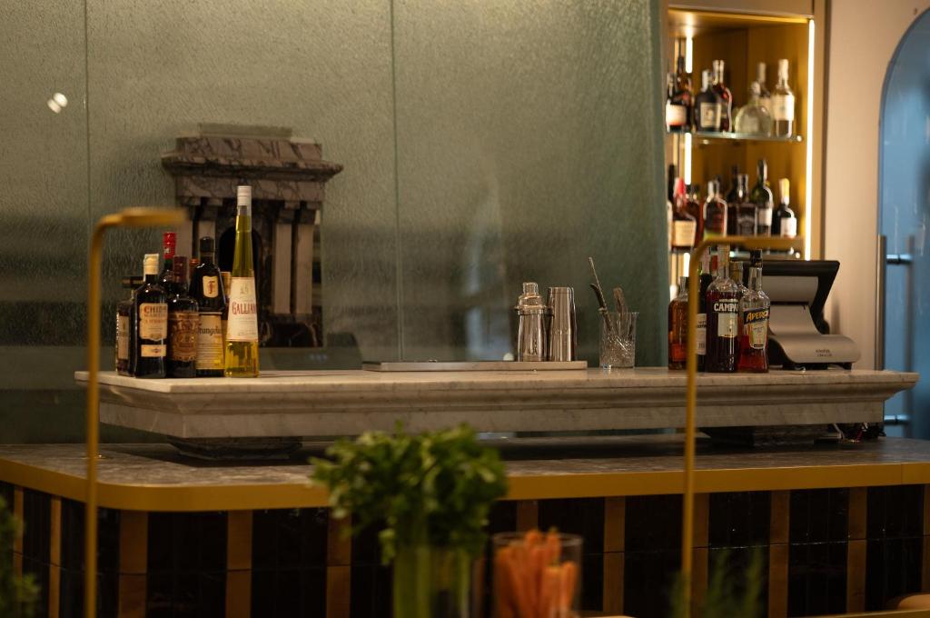 a bar with bottles of alcohol on a counter at Maison Roma Piazza di Spagna UNA Esperienze in Rome