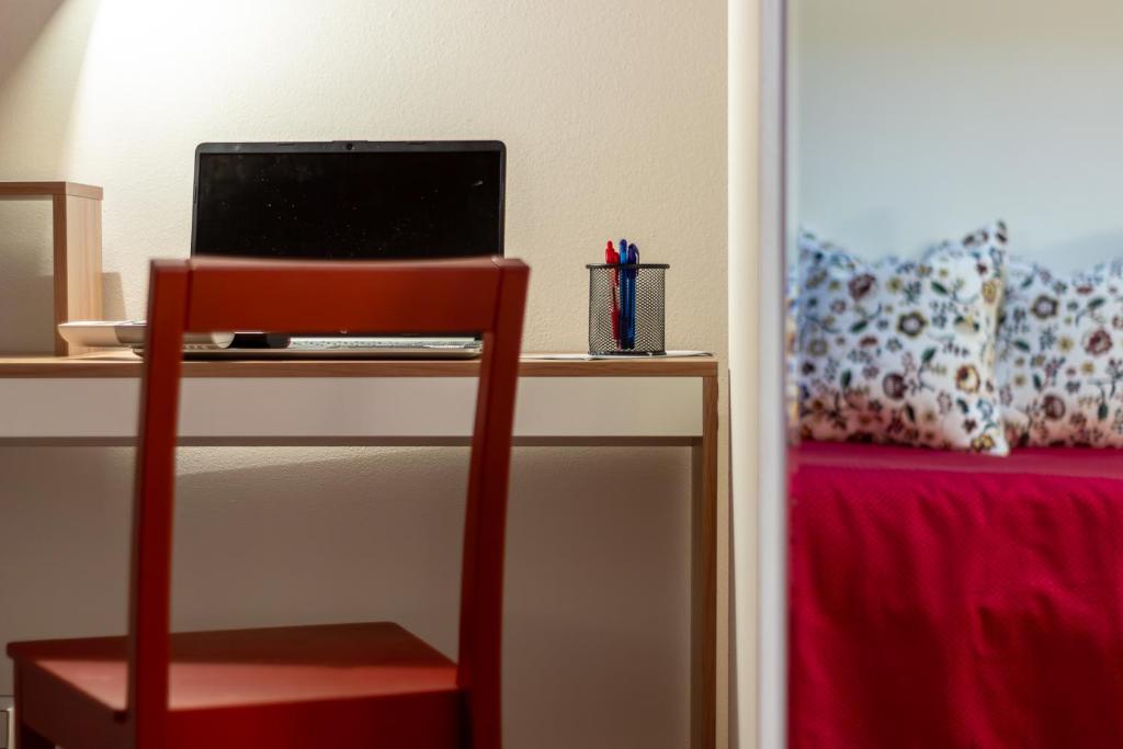 a desk with a laptop computer on top of it at CasaCri in Cittiglio