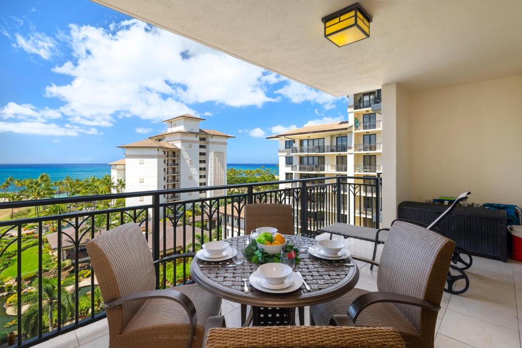 a balcony with a table and chairs and the ocean at Ko Olina Beach Villas O805 in Kapolei