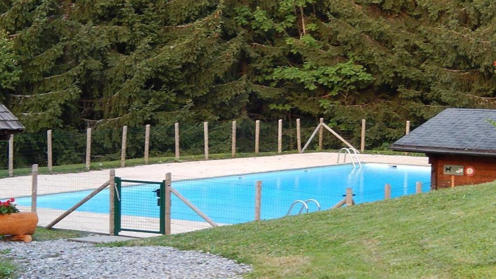 une grande piscine bleue dans une cour dans l'établissement Studio Bettex Pierre Platte, à Saint-Gervais-les-Bains