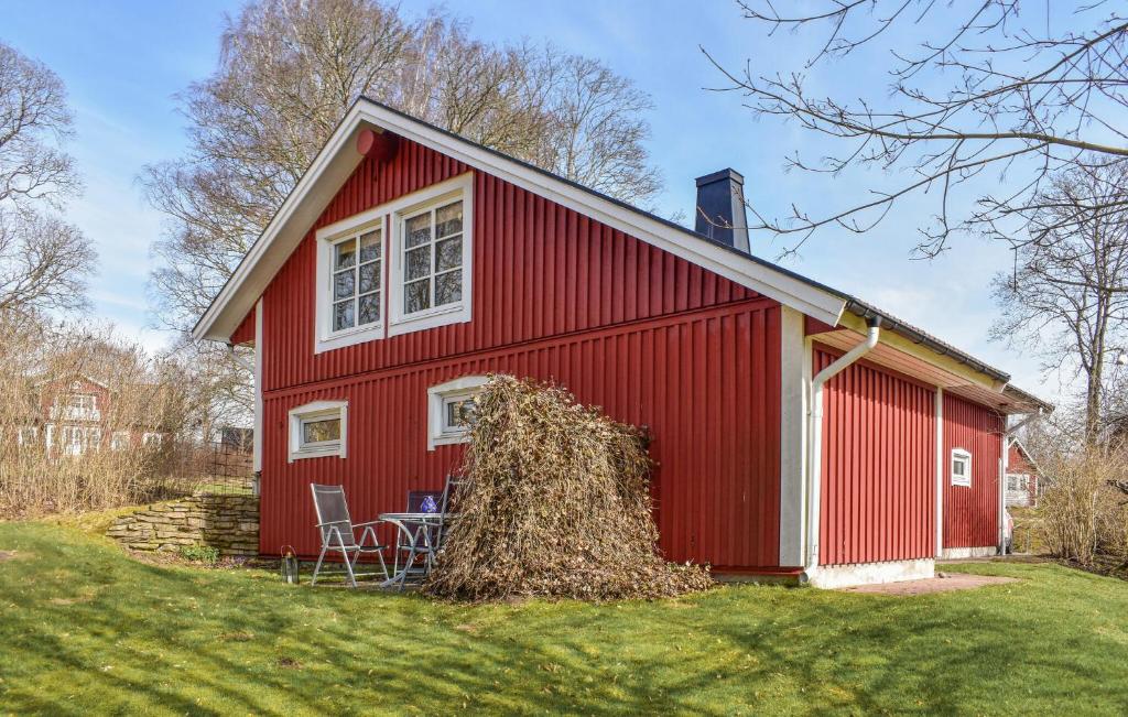 a red barn with a stack of hay at Lovely Apartment In Markaryd With Lake View in Markaryd
