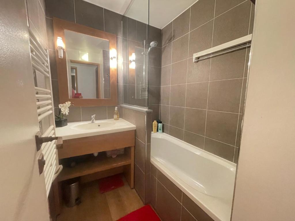 a bathroom with a sink and a bath tub at Les Balcons de Bellevarde in Val-d'Isère