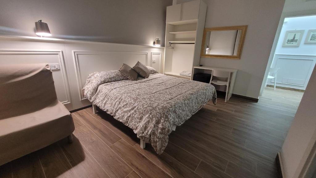 Dormitorio pequeño con cama y espejo en Vomero House, en Nápoles