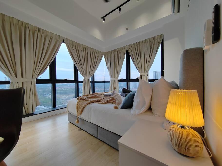 Schlafzimmer mit einem Bett und großen Fenstern in der Unterkunft Cozy 2bedroom # Revo Bukit Jalil #Pavillion 2 in Kuala Lumpur