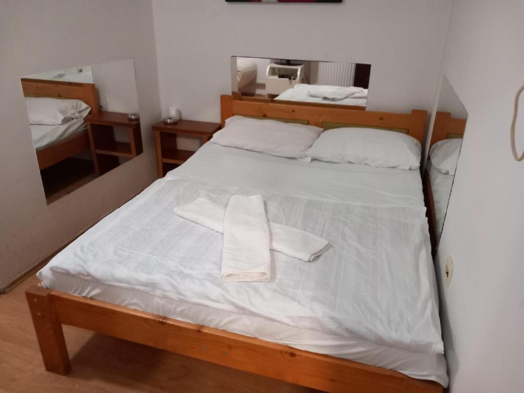 a bedroom with a bed with two towels on it at HOSTEL WIEN in Barakovići