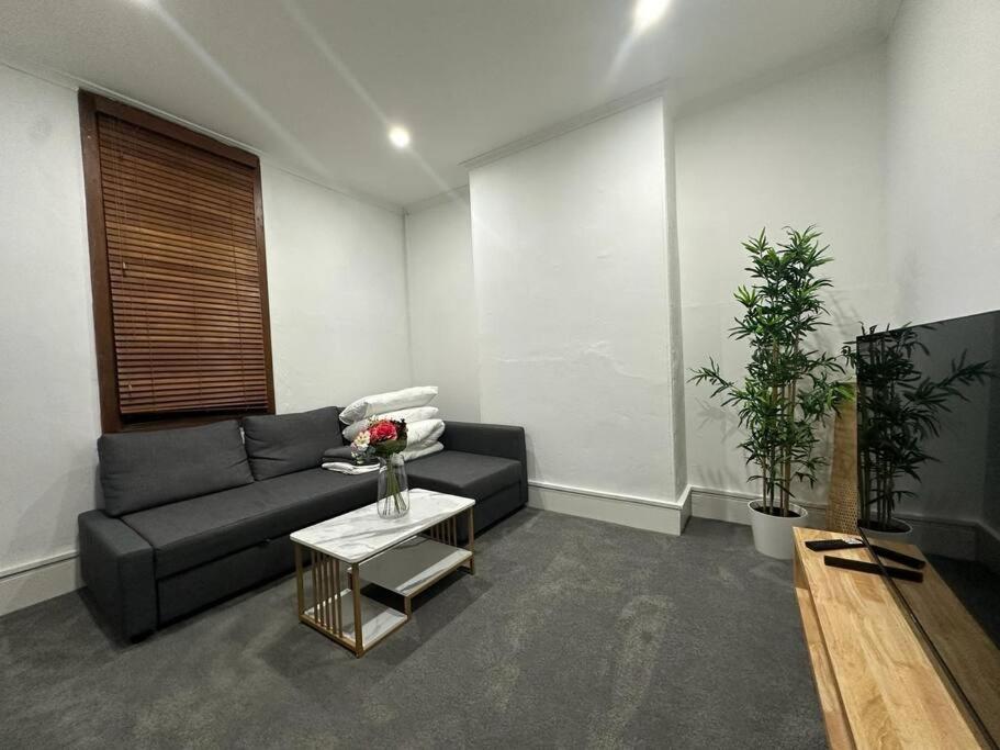 a living room with a couch and a table at Remarkable 2 Bedroom House at the Centre of Darlinghurst in Sydney