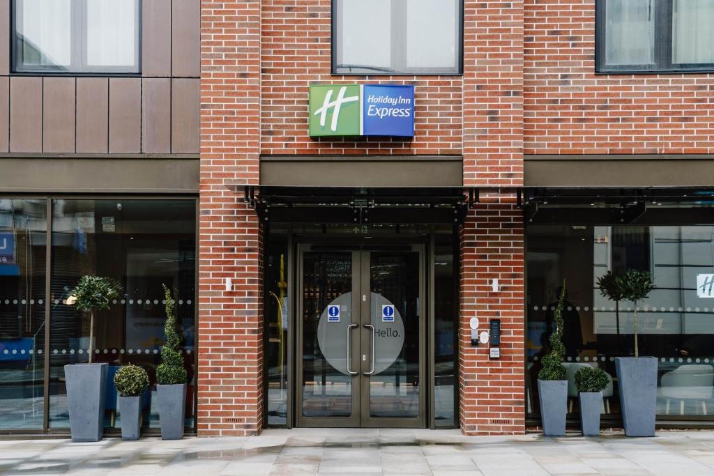 a entrance to a brick building with a revolving door at Holiday Inn Express Liverpool - Central, an IHG Hotel in Liverpool