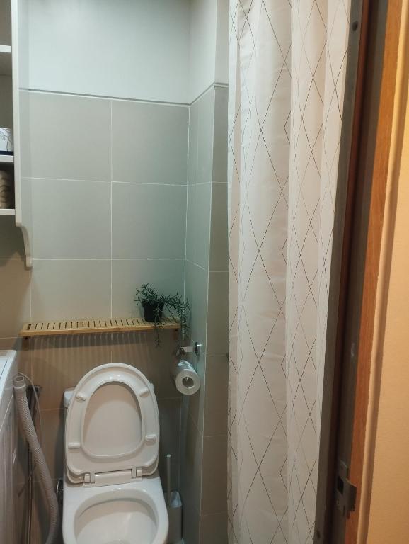 a small bathroom with a toilet and a shower at S Residences in Manila
