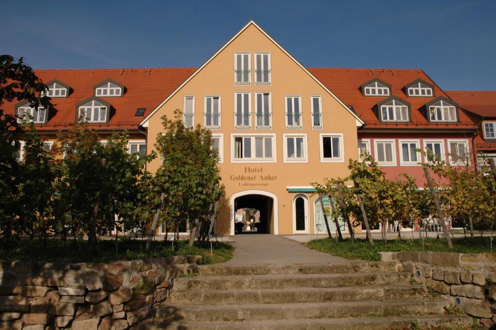 a large building with stairs in front of it at Hotel Goldener Anker in Radebeul
