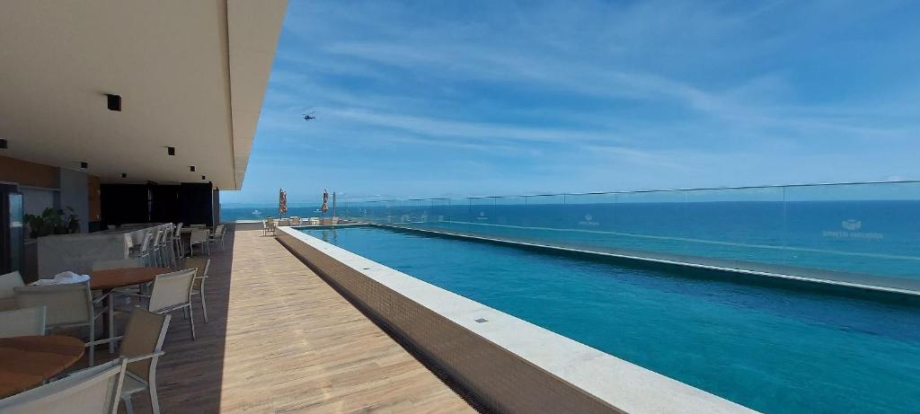 a swimming pool with a view of the ocean at COSTE0104 - Premium Stella Maris in Salvador