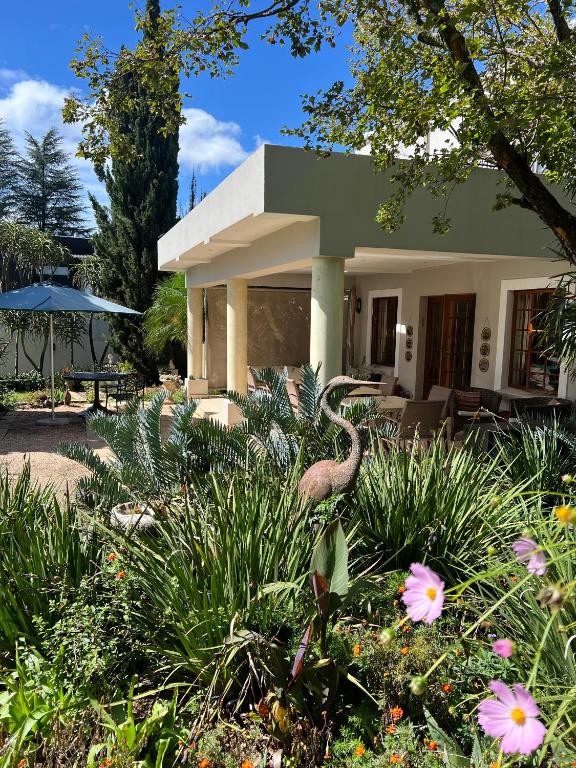 a house with a bird in front of it at Highgrove Guesthouse Morningside Sandton in Sandton
