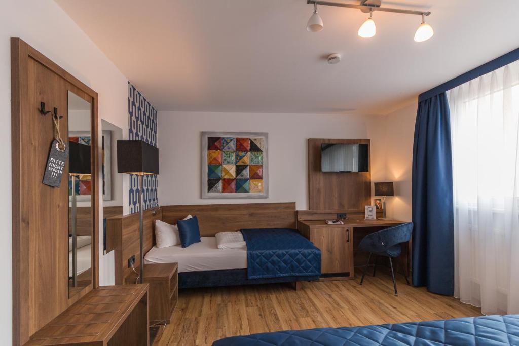 Säng eller sängar i ett rum på Hotel am Brauerei-Dreieck