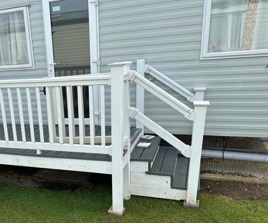 a porch with a white railing on a house at 4-Bedroom Caravan static home in Clacton-on-Sea in Clacton-on-Sea