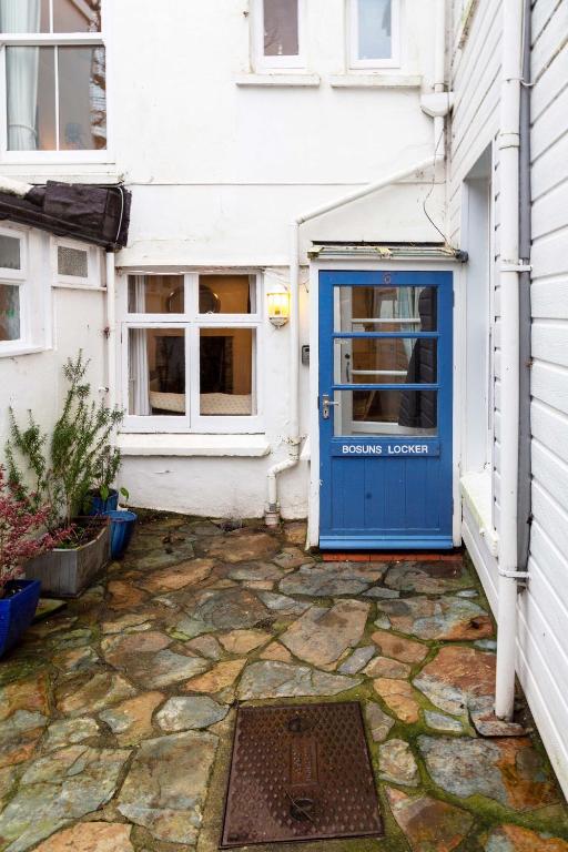 a blue door on the side of a house at Bosuns Locker in Port Isaac