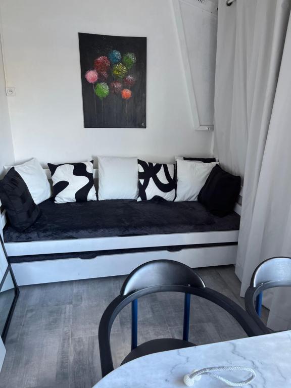 a couch with pillows on it in a room at LOCATION CAP D'AGDE in Cap d'Agde
